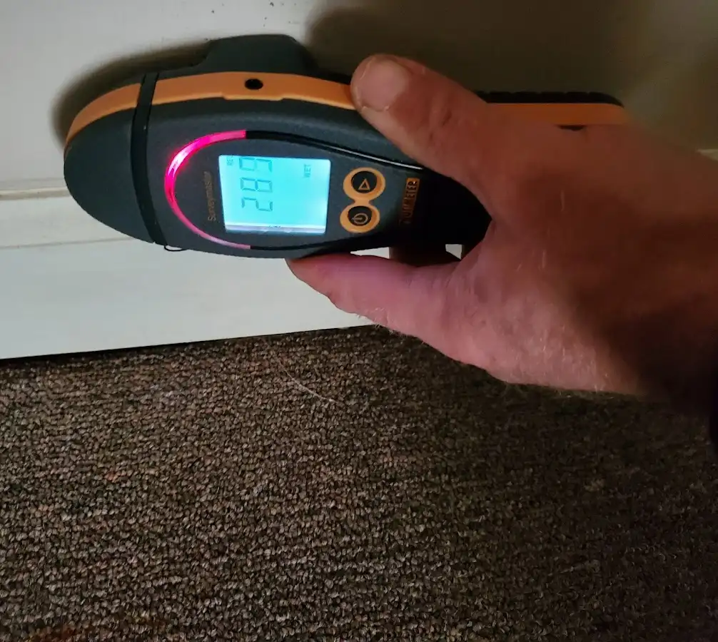 Moisture detection at baseboard during Storm Damage Restoration in Fairview